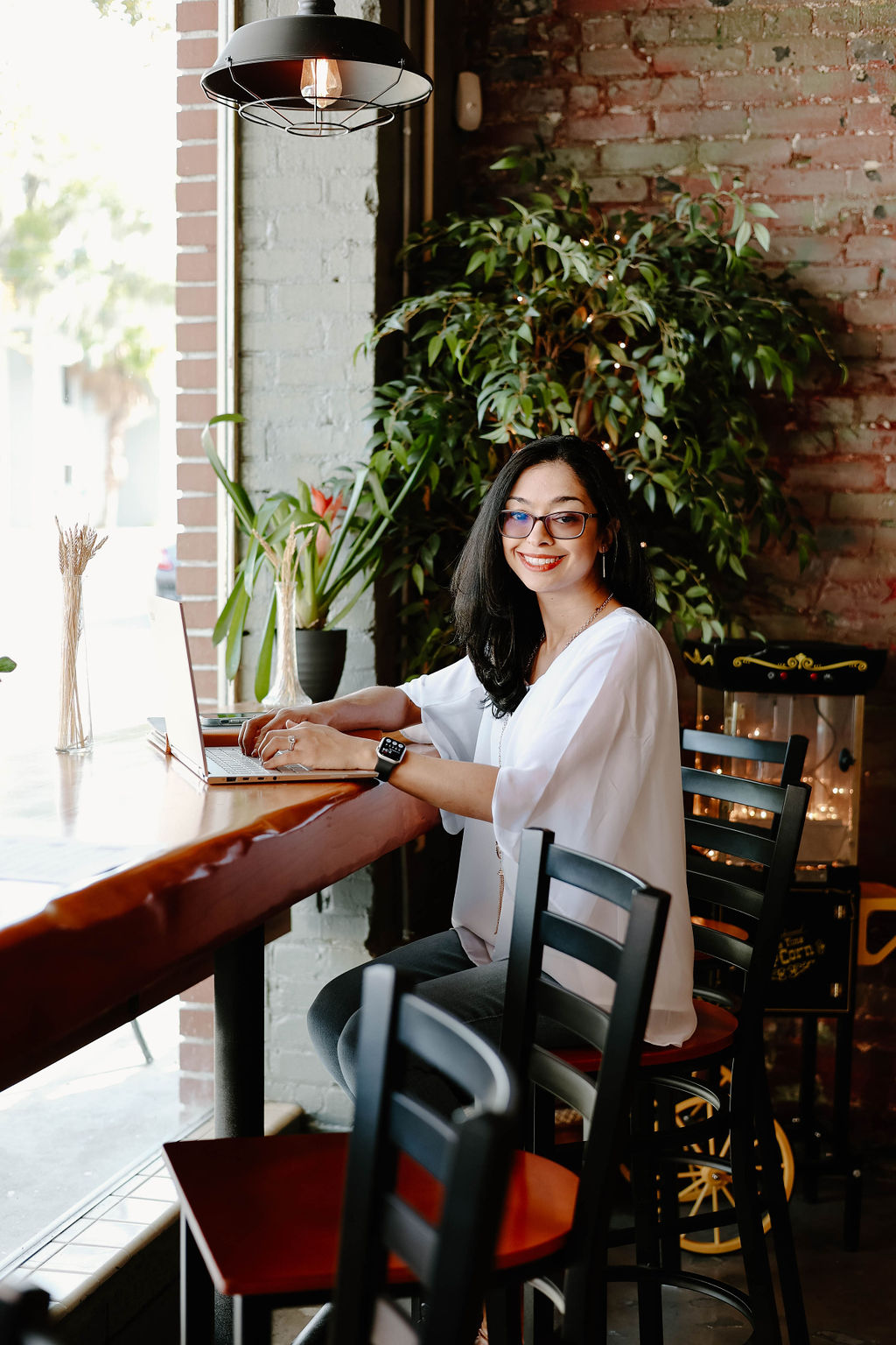 Vanette Cotto, Enrolled Agent, seated by a window